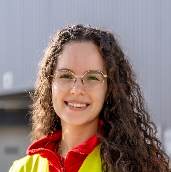 Happy warehouse woman worker standing outside the building